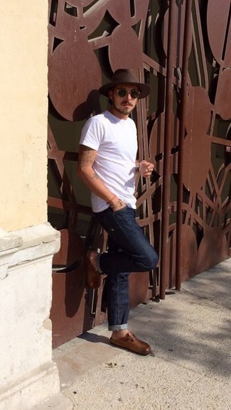 Как носить темно-синие джинсы с коричневыми кожаными лоферами мужчине