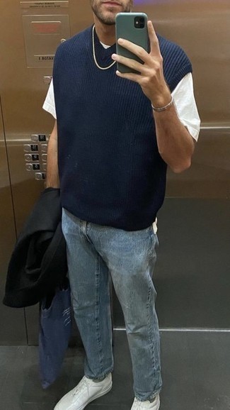 Как носить темно-синий трикотажный жилет с черным длинным пальто