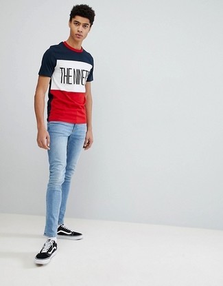 Модный лук: бело-красно-синяя футболка с круглым вырезом с принтом, голубые зауженные джинсы, черно-белые низкие кеды из плотной ткани, белые носки