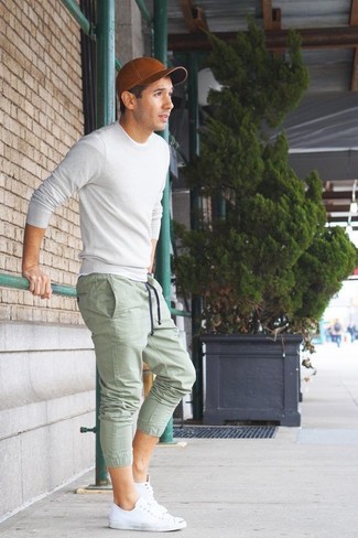 С чем носить белые низкие кеды мужчине: Белый свитер с круглым вырезом и зеленые спортивные штаны — обязательные элементы современного мужского гардероба. Вместе с этим ансамблем органично выглядят белые низкие кеды.