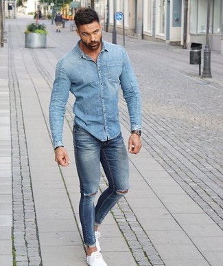 Какие джинсовые рубашки носить с белыми низкими кедами мужчине в спортивном стиле: Сочетание джинсовой рубашки и синих рваных зауженных джинсов - очень практично, и поэтому идеально для создания повседневного  ансамбля. Думаешь сделать образ немного элегантнее? Тогда в качестве обуви к этому луку, стоит обратить внимание на белые низкие кеды.