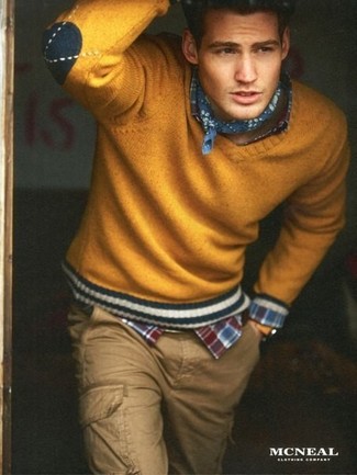 С чем носить горчичный свитер с v-образным вырезом мужчине: Горчичный свитер с v-образным вырезом и светло-коричневые брюки карго украсят гардероб любого мужчины.