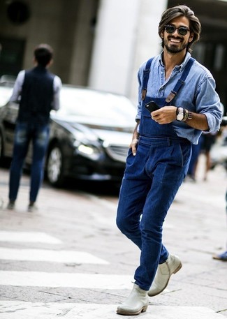 Модный лук: голубая джинсовая рубашка, синие джинсовые штаны-комбинезон, серые кожаные ботинки челси, черные солнцезащитные очки