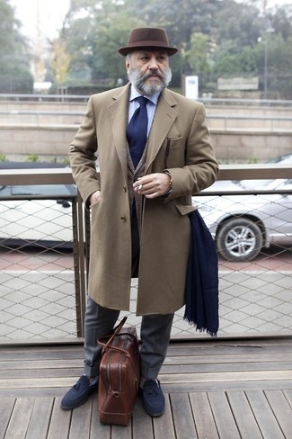 С чем носить темно-синие лоферы с кисточками за 60 лет в холод: Коричневое длинное пальто в паре с темно-серыми классическими брюками — образец строгого делового стиля. Дерзкие мужчины дополнят образ темно-синими лоферами с кисточками.