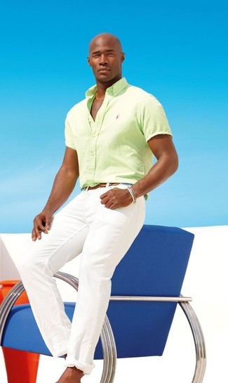 С чем носить зелено-желтую рубашку с коротким рукавом мужчине: Ансамбль из зелено-желтой рубашки с коротким рукавом и белых брюк чинос поможет создать необыденный мужской образ в стиле casual.