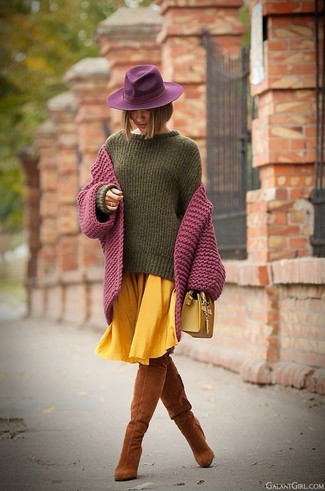 Как носить свободный свитер с ботфортами в 30 лет: Свободный свитер будет выглядеть великолепно в сочетании с желтой юбкой-миди со складками. Любишь яркие сочетания? Дополни образ ботфортами.