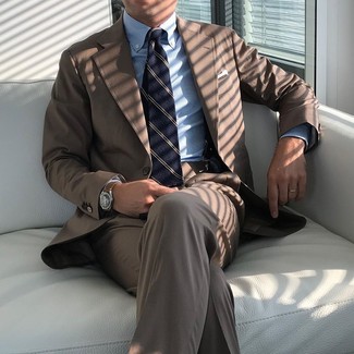 С чем носить коричневый костюм в теплую погоду: Комбо из коричневого костюма и голубой классической рубашки в вертикальную полоску позволит создать стильный и изысканный образ.