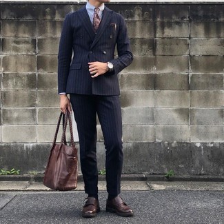 С чем носить темно-коричневый галстук с "огурцами" мужчине в теплую погоду: Темно-синий костюм в вертикальную полоску в сочетании с темно-коричневым галстуком с "огурцами" поможет создать стильный классический образ. Что касается обуви, можешь отдать предпочтение практичности и надеть на ноги темно-коричневые кожаные монки с двумя ремешками.