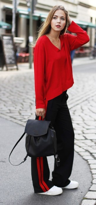 С чем носить темно-красные широкие брюки весна: Дуэт красной блузки с длинным рукавом и темно-красных широких брюк позволит реализовать в твоем луке современный городской стиль. Создать эффектный контраст с остальными составляющими этого лука помогут белые низкие кеды. Это сочетание вещей чудесно подойдет для межсезонья, когда холодная пора отступает и сменяется более теплыми деньками.