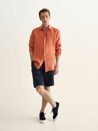 Какие низкие кеды носить с темно-синими шортами мужчине: Лук из оранжевой рубашки с длинным рукавом и темно-синих шорт — образец современного городского стиля. В тандеме с этим образом стильно выглядят низкие кеды.