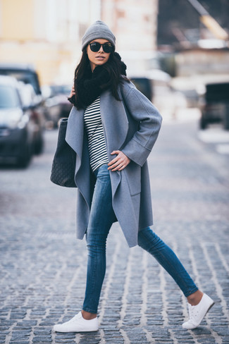 С чем носить серое пальто женщине в прохладную погоду: Сочетание серого пальто и синих джинсов скинни поможет подчеркнуть твою индивидуальность. Создать стильный контраст с остальными элементами этого ансамбля помогут белые низкие кеды.