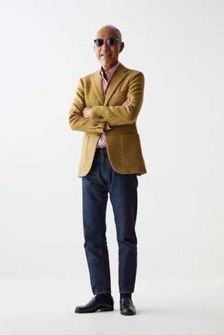 С чем носить горчичный шерстяной пиджак мужчине: Горчичный шерстяной пиджак в сочетании с темно-синими джинсами — великолепный пример непринужденного офисного стиля для парней. Если ты любишь смелые настроения в своих луках, закончи этот черными кожаными лоферами.
