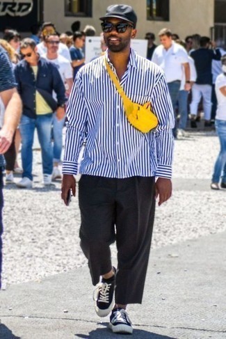 С чем носить желтую поясную сумку в 30 лет мужчине: Если ты делаешь ставку на удобство и функциональность, бело-темно-синяя рубашка с длинным рукавом в вертикальную полоску и желтая поясная сумка — хороший вариант для модного повседневного мужского лука. Любители экспериментировать могут дополнить образ черно-белыми низкими кедами из плотной ткани, тем самым добавив в него немного классики.