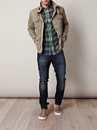Модный лук: светло-коричневая полевая куртка, темно-сине-зеленая рубашка с длинным рукавом в шотландскую клетку, темно-синие зауженные джинсы, коричневые низкие кеды