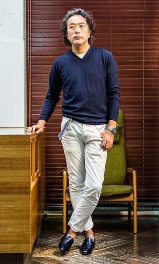 С чем носить темно-сине-белый свитер за 40 лет мужчине: Темно-сине-белый свитер и белые брюки чинос прочно обосновались в гардеробе современных джентльменов, помогая составлять запоминающиеся и стильные ансамбли. Любители экспериментов могут дополнить лук темно-синими кожаными лоферами, тем самым добавив в него чуточку строгости.
