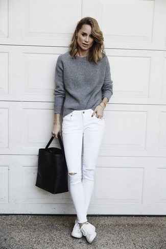 Модный лук: серый свитер с круглым вырезом, белые рваные джинсы скинни, белые кожаные низкие кеды, черная кожаная большая сумка