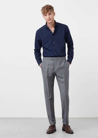 С чем носить темно-синюю рубашку в 30 лет мужчине в теплую погоду: Темно-синяя рубашка в сочетании с серыми классическими брюками поможет составить стильный и мужественный лук. Завершив ансамбль темно-коричневыми кожаными монками, можно получить неожиданный результат.