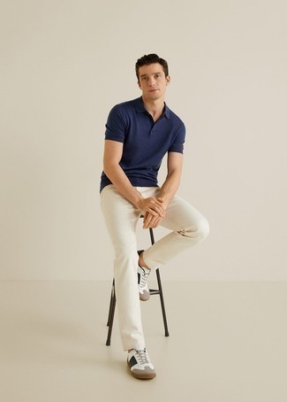 Какие джинсы носить с бело-черными низкими кедами мужчине: Если ты любишь смотреться с иголочки, чувствуя себя при этом комфортно и расслабленно, стоит примерить это сочетание темно-синей футболки-поло и джинсов. Бело-черные низкие кеды органично дополнят этот образ.