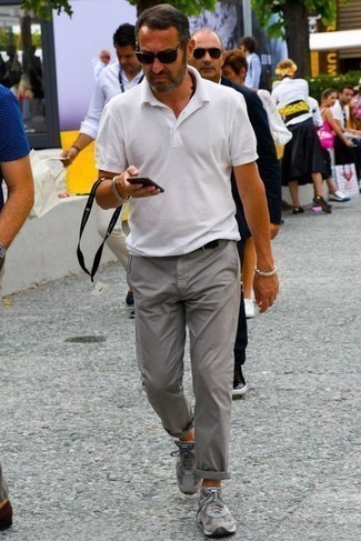 С чем носить серые кроссовки за 40 лет мужчине в жару: Белая футболка-поло и серые брюки чинос — неотъемлемые вещи в гардеробе джентльменов с чувством стиля. Тебе нравятся смелые сочетания? Закончи свой образ серыми кроссовками.