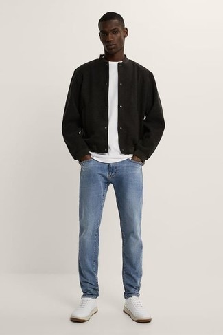 Как носить университетскую куртку с джинсами в 20 лет мужчине: Если ты любишь выглядеть с иголочки, и при этом чувствовать себя комфортно и нескованно, попробуй это сочетание университетской куртки и джинсов. Белые кожаные низкие кеды — беспроигрышный выбор, чтобы завершить лук.