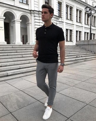 С чем носить черную футболку-поло мужчине: Сочетание черной футболки-поло и серых брюк чинос поможет создать модный мужской образ. Белые кожаные низкие кеды станут хорошим дополнением к твоему луку.