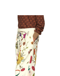 Бежевые брюки чинос с цветочным принтом от Gucci