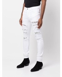 Мужские белые рваные зауженные джинсы от Amiri