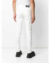 Мужские белые рваные зауженные джинсы от Balmain