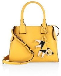 Желтая кожаная сумка с геометрическим рисунком