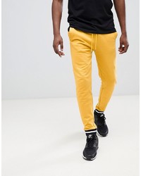 Мужские желтые спортивные штаны от ASOS DESIGN