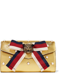 Золотой кожаный клатч с украшением от Gucci