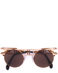 Женские золотые солнцезащитные очки от Cazal