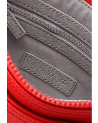 Красная сумка через плечо от Lacoste