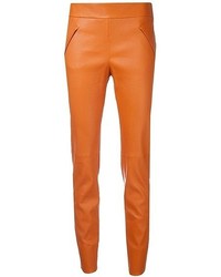 Оранжевые кожаные брюки
