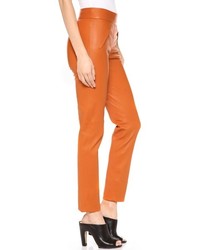 Оранжевые кожаные узкие брюки