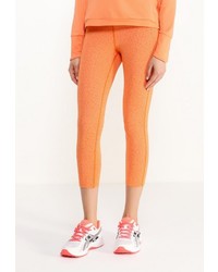 Оранжевые леггинсы от Asics