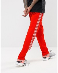 Мужские оранжевые спортивные штаны от adidas