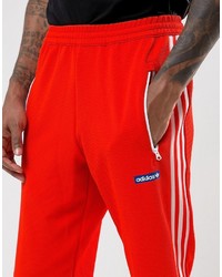 Мужские оранжевые спортивные штаны от adidas