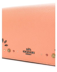 Оранжевый кожаный клатч от Coach