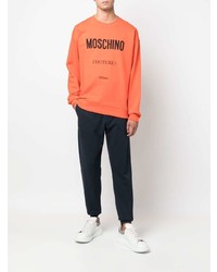 Мужской оранжевый флисовый свитшот с принтом от Moschino