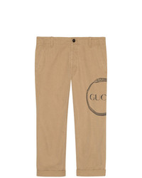 Светло-коричневые брюки чинос с принтом от Gucci