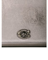 Серебряный кожаный клатч от Coach