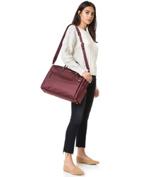 Женская темно-красная сумка от Tumi