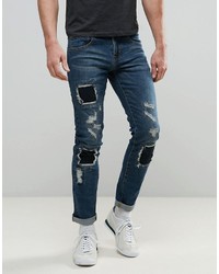 Мужские темно-синие рваные зауженные джинсы