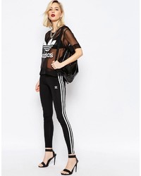 Черно-белые леггинсы в вертикальную полоску от adidas