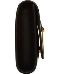 Черно-золотой кожаный клатч с украшением от Saint Laurent