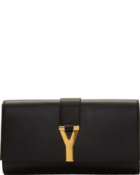Черно-золотой кожаный клатч с украшением от Saint Laurent