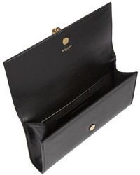 Черно-золотой кожаный клатч от Saint Laurent