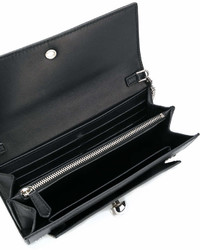Черный кожаный клатч с шипами от Alexander McQueen